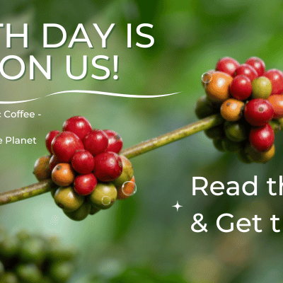 Coffee cherries on a branch with promotional text for Earth Day and organic coffee.