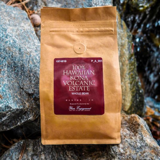 Kona Volcanic Estate coffee bag on a rocky surface