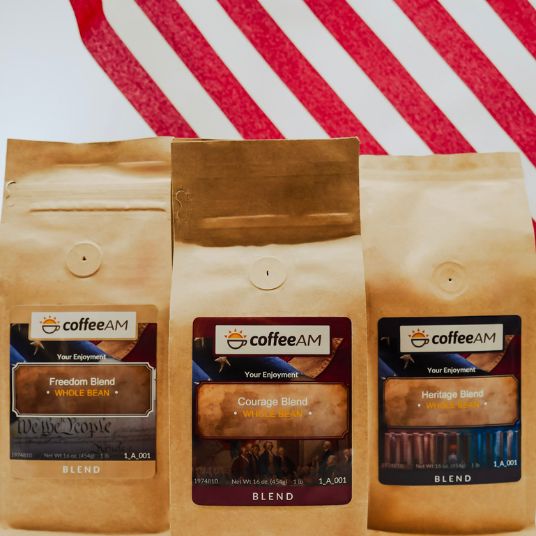 Three coffee AM bags with different blends on a red and white striped background
