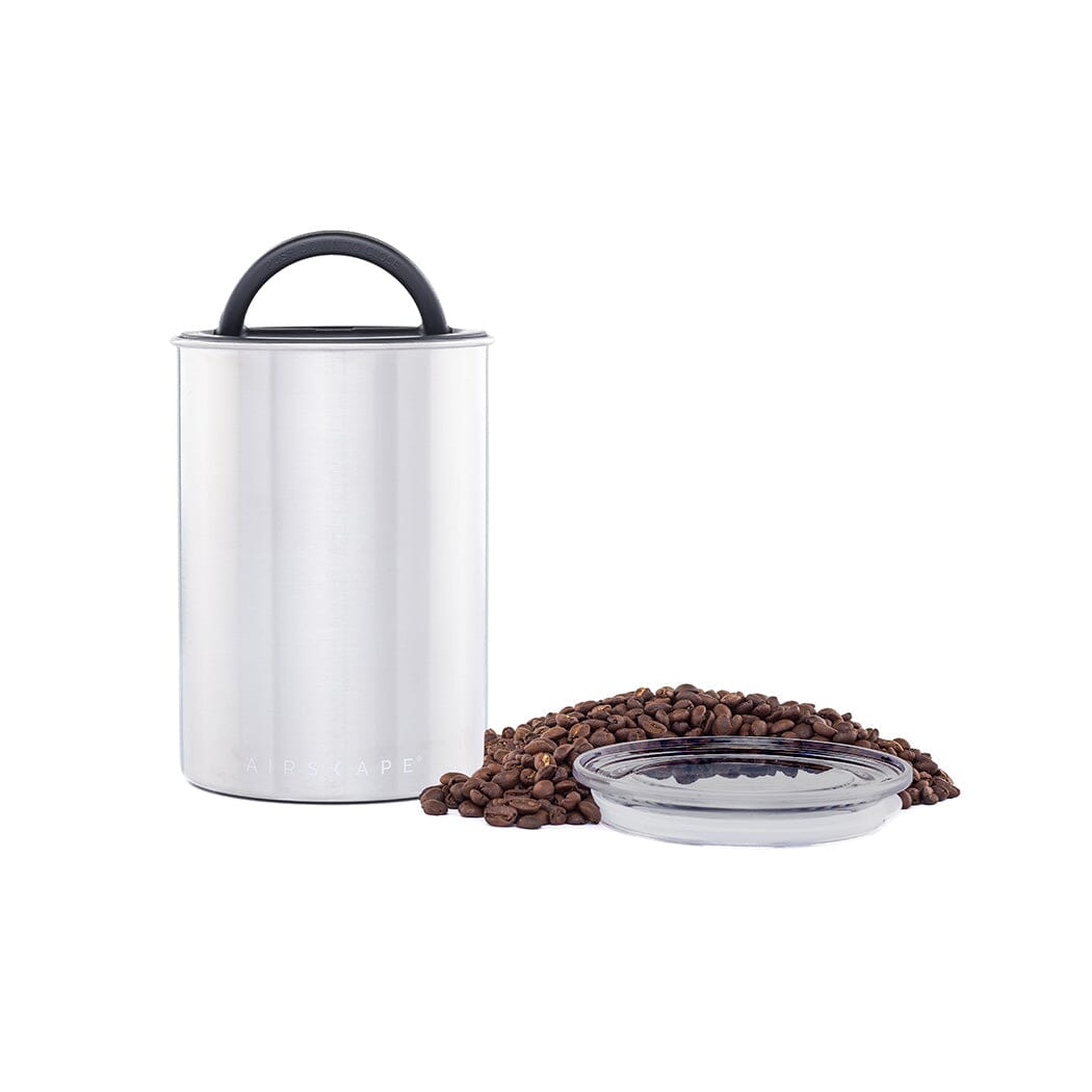 Silver coffee canister with a black handle on a white background