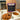 CoffeeAM Almond Toffee Crunch coffee package with a cup of coffee and almonds on a tray.