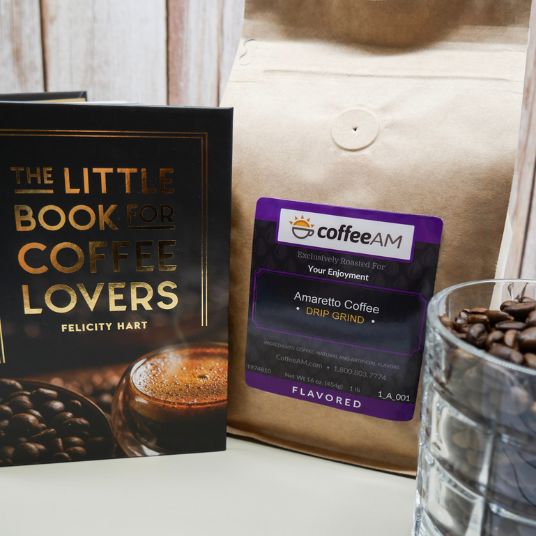 Coffee AM bag with a label, 'The Little Book for Coffee Lovers' book, and glass of coffee beans.
