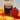 Coffee AM bag of Aztec Gold Espresso with a colorful beaded pouch on an orange fabric background