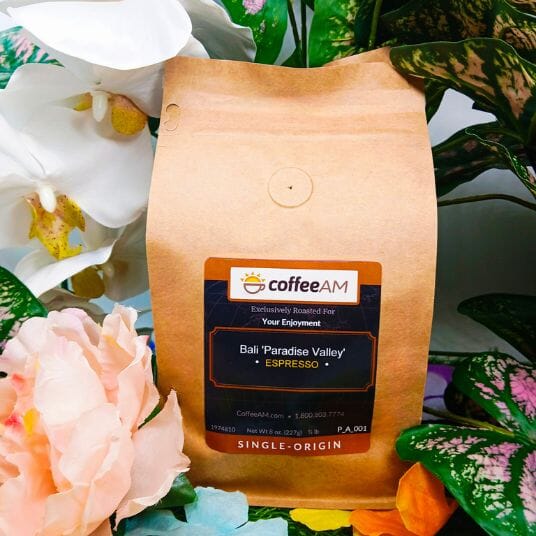 CoffeeAM Bali 'Paradise Valley' Espresso coffee bag with flowers in the background