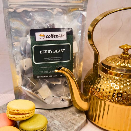 Tea package labeled 'coffee AM Berry Blast' with a background of berries