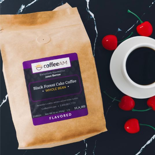 CoffeeAM Black Forest Cake coffee package with a cup of coffee and cherries on a dark background