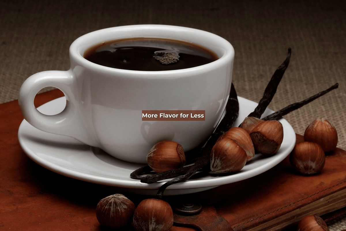 Cup of coffee surrounded by hazelnuts and vanilla with text that reads " More Flavor for Less!"