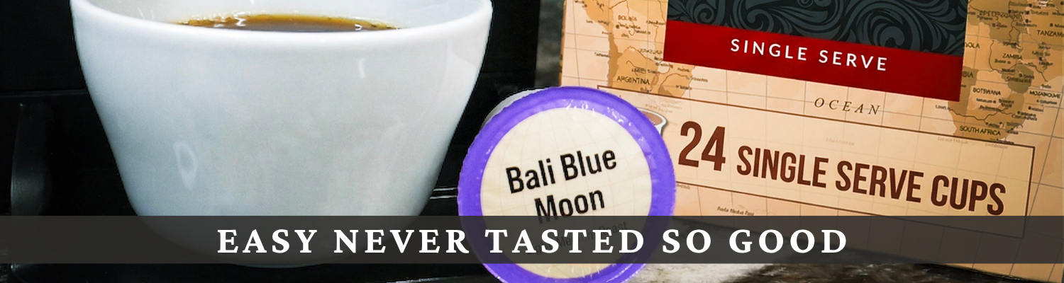 A single-serve coffee cup package labeled Bali Blue Moon with a white coffee cup, a map-style background, and the text 'EASY NEVER TASTED SO GOOD' across the bottom.