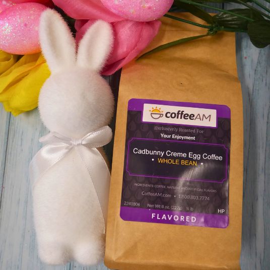 CoffeeAM Cadbunny Creme Egg Coffee package with a decorative bunny and flowers on a wooden surface