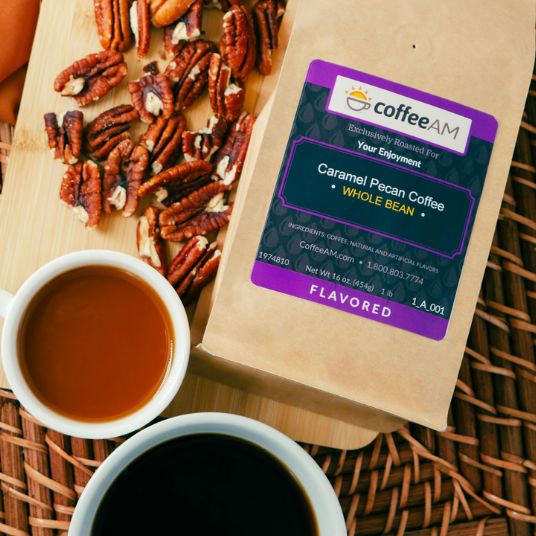 Caramel pecan coffee package with a cup of coffee and pecans on a wooden board