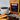 CoffeeAM chocolate-dipped almond biscotti coffee package with a cup of coffee and treats on a wooden surface.