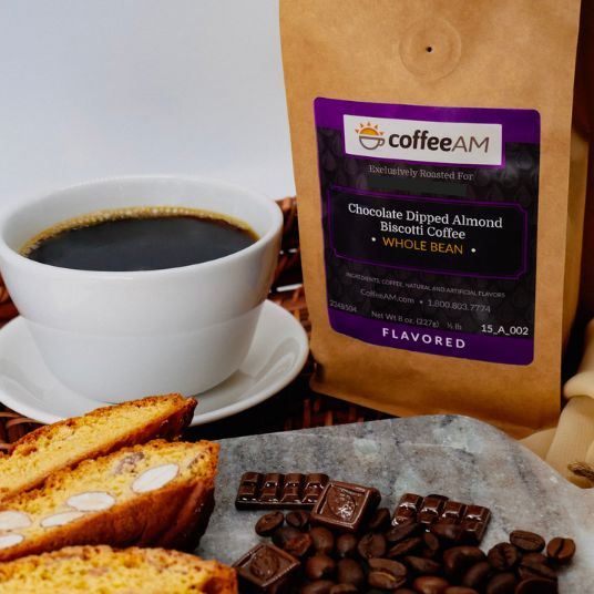 CoffeeAM chocolate-dipped almond biscotti coffee package with a cup of coffee and treats on a wooden surface.
