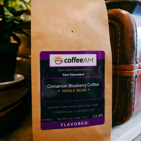 CoffeeAM cinnamon blueberry coffee package on a wooden surface with a blurred background