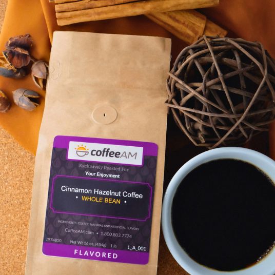 Kraft paper coffee bag with 'coffee AM' label next to a cup of coffee on a wooden surface.