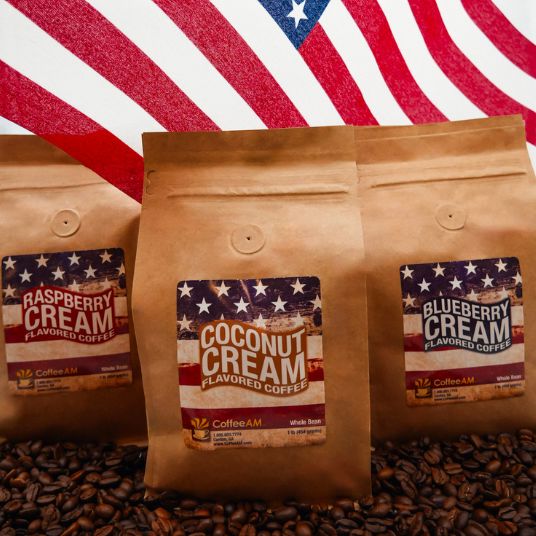 Three coffee packages with 'Coconut Cream' flavor label in front of an American flag background.