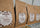Several brown paper coffee bags on a metal shelf, each with a white label reading Coffee Crusaders Co. and Colombia Supremo.