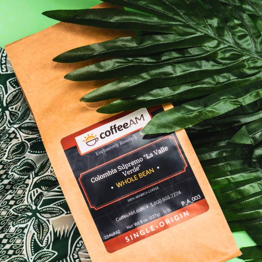 CoffeeAM coffee package with a label on a green leaf background