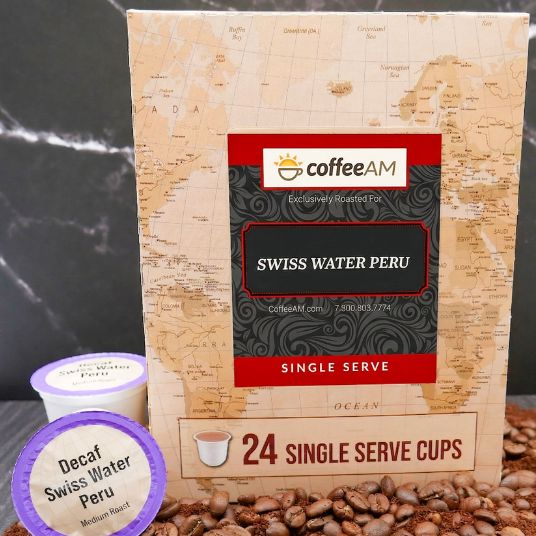 Box of Coffee AM Swiss Water Peru single serve coffee cups with a scenic background