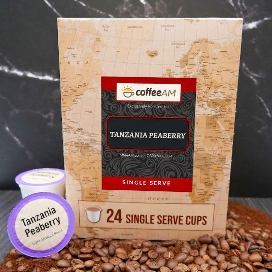 Box of Coffee AM Tanzania Peaberry single serve coffee cups with a scenic background