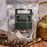 Package of CoffeeAM Authentic Chai Masala tea with loose tea on a wooden surface.