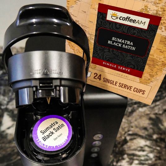 Box of Coffee AM Sumatra Black Satin single serve coffee cups with architectural background