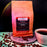 Coffee AM bag with coffee beans and a cup on a colorful background