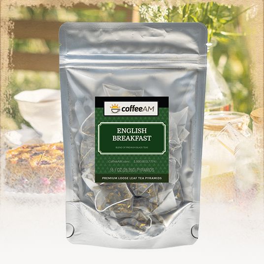 Pack of English Breakfast tea with 'coffee AM' branding against a blurred outdoor background