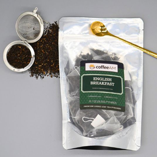Pack of English Breakfast tea with 'coffee AM' branding against a blurred outdoor background