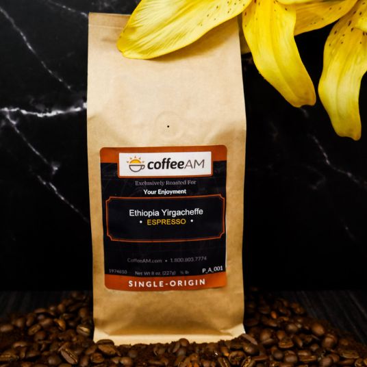 Coffee AM Ethiopia Yirgacheffe Espresso coffee bag with yellow flowers on a dark surface