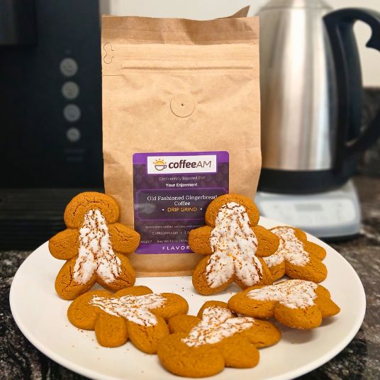 Gingerbread-men shaped cookies on a plate with a bag of coffee AM in the background.