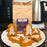 Gingerbread-men shaped cookies on a plate with a bag of coffee AM in the background.