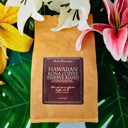 Hawaiian Kona Coffee Reserve Blend package with flowers and leaves in the background