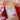 Kraft paper coffee bag with 'Heart of Gold' label surrounded by flowers and decorative hearts on a red background