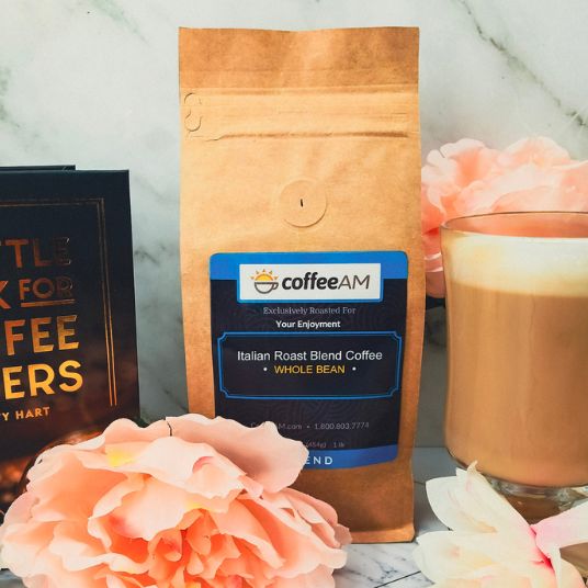 Coffee AM coffee bag with a glass of coffee and flowers on a marble surface