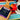 CoffeeAM Mexican Liqueur & Cream coffee package with a maraca and cup of coffee on a colorful fabric background