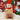 Elf plush toy on a Nutmeg Spice coffee bag with Christmas decorations in the background