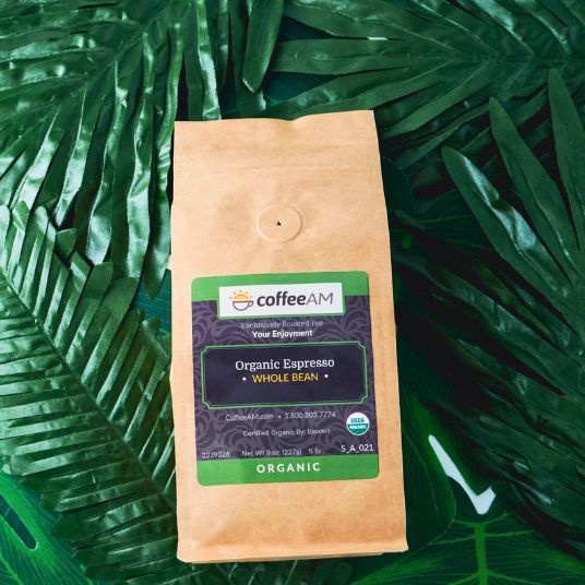 CoffeeAM Organic Espresso whole bean package on a green leaf background