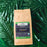 CoffeeAM Organic Espresso whole bean package on a green leaf background