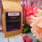 CoffeeAM pastel Jordan Almond coffee package with flowers on a wooden surface