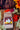 A kraft paper bag of CoffeeAM "Pecan Pie" flavored coffee positioned against an autumn-themed background featuring colorful orange, red, and yellow leaves, cinnamon sticks, and festive holiday decor.