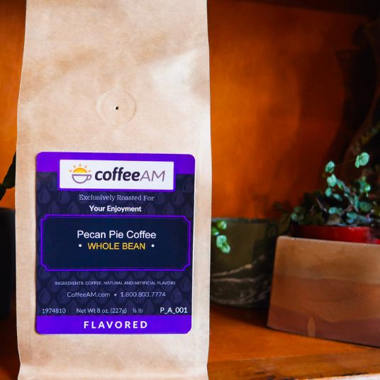 CoffeeAM pecan pie coffee package on a wooden surface with a blurred background
