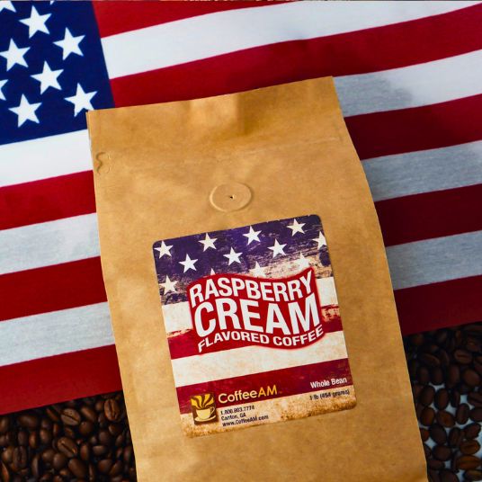 Bag of Raspberry Cream flavored coffee with a label on an American flag background