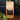 CoffeeAM Tanzania Peaberry coffee bag on a dark surface with coffee beans and greenery.