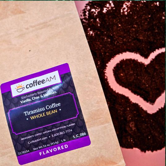 CoffeeAM Tiramisu Coffee package on a brown surface with a heart-shaped design in the background.