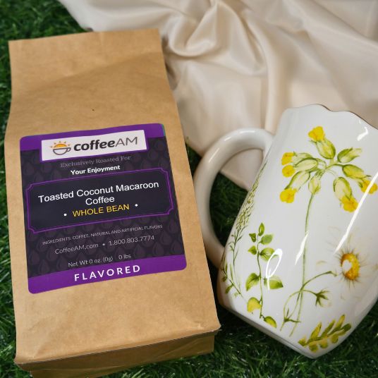Coffee AM toasted coconut macaroon coffee package with a floral mug on grass