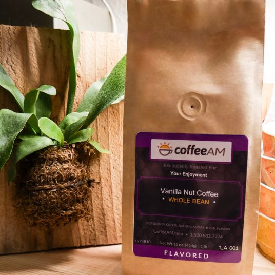 CoffeeAM vanilla nut coffee bag with a plant in the background